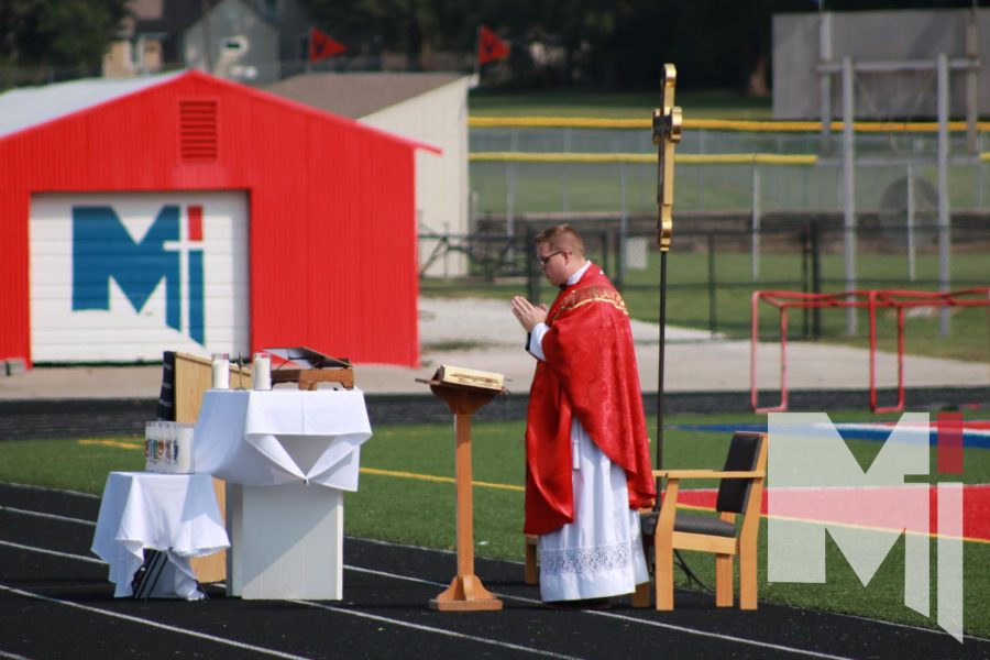 Father Anthony Mersmann says the first Mass of the school year outside. As a new member of the staff, this was Mersmanns first time giving Mass at Miege, and due to the pandemic, it brought challenges for CMT.