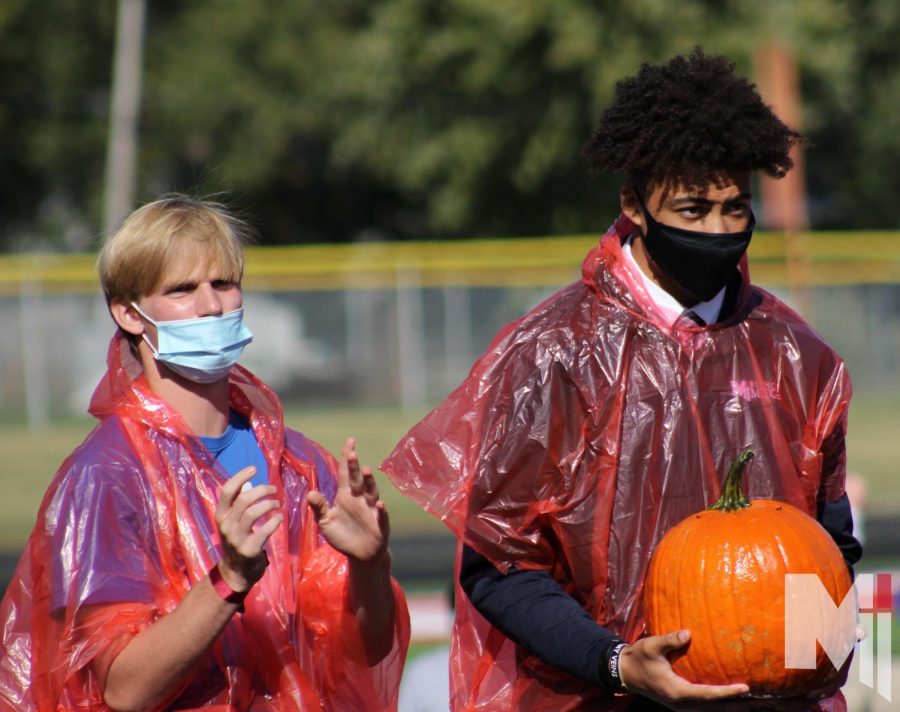 Participating in the pumpkin race, sophomore Stephen Neenan and freshman Keelan Smith prepare to race. The pumpkins used in the competition were covered in baby oil to add an extra challenge.