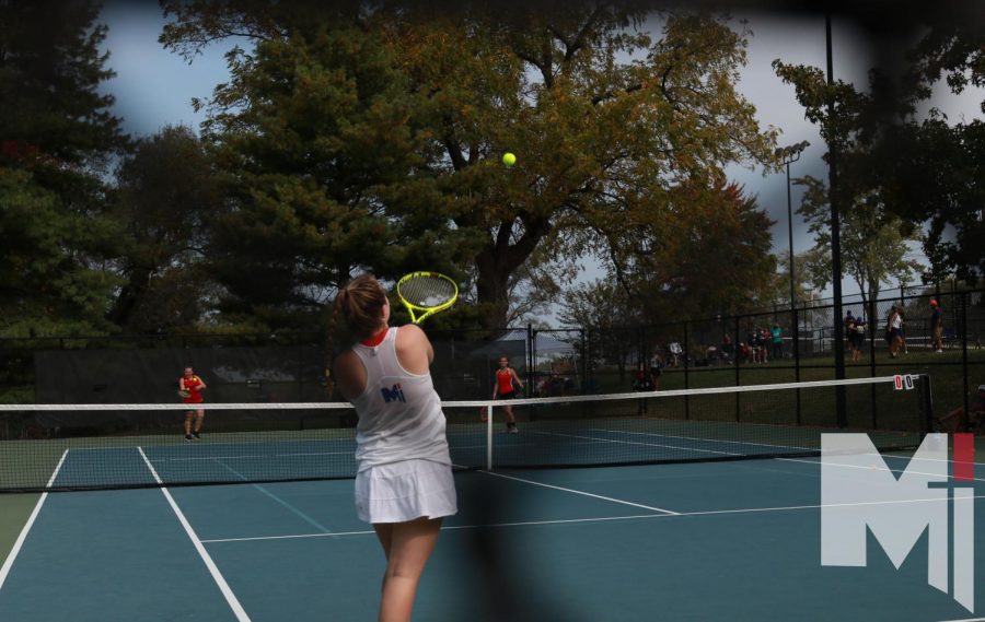 Senior Riley Hagen warms up her serve against her first opponent before her doubles match.