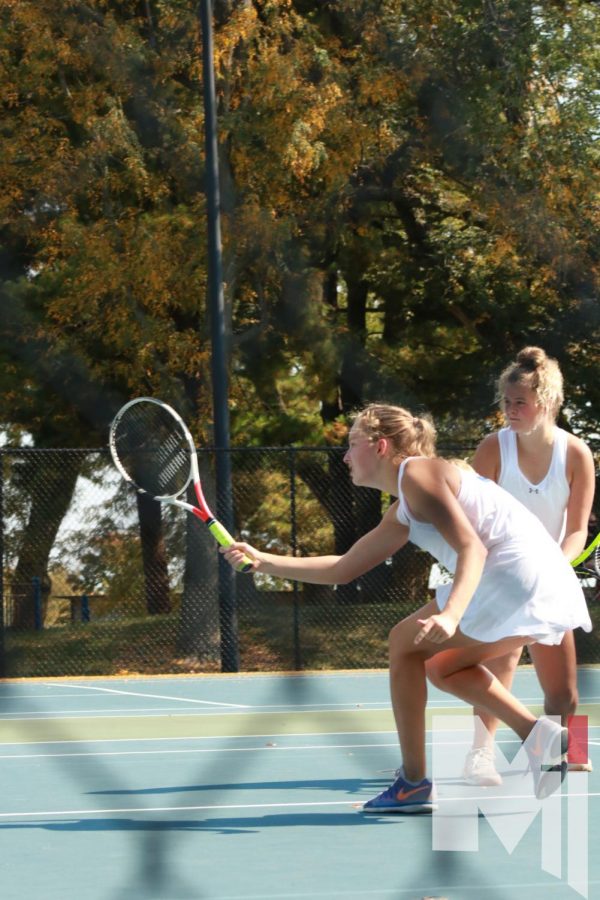Senior Delaney Pepin and Freshman Livi Shull play the net during a doubles match at Regionals.