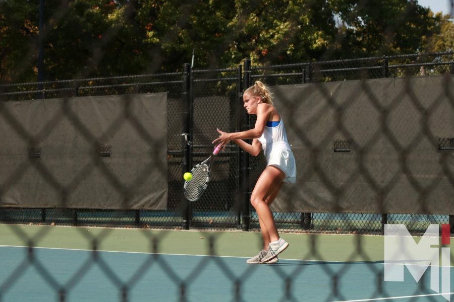 Senior Mariel Allen swings at a ball against her opponent at Regionals. 