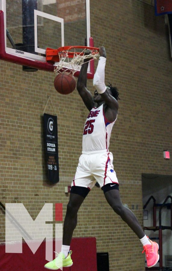 Junior Mark Mitchell goes up for a dunk for a 68-37 victory against Shawnee Mission North for the Stags’ first game.