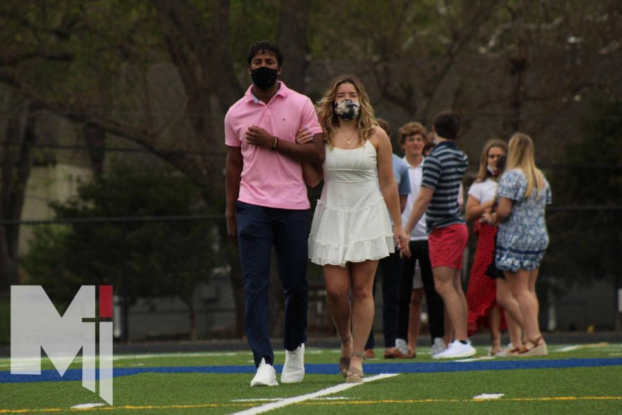 Seniors Timmy Dorsey and Layne Fortin are introduced as Prom Court nominees as they walk down the field. The 2021 Prom Court has been expanded to 14 seniors, to make up for the lack of Sadies Court this year. 