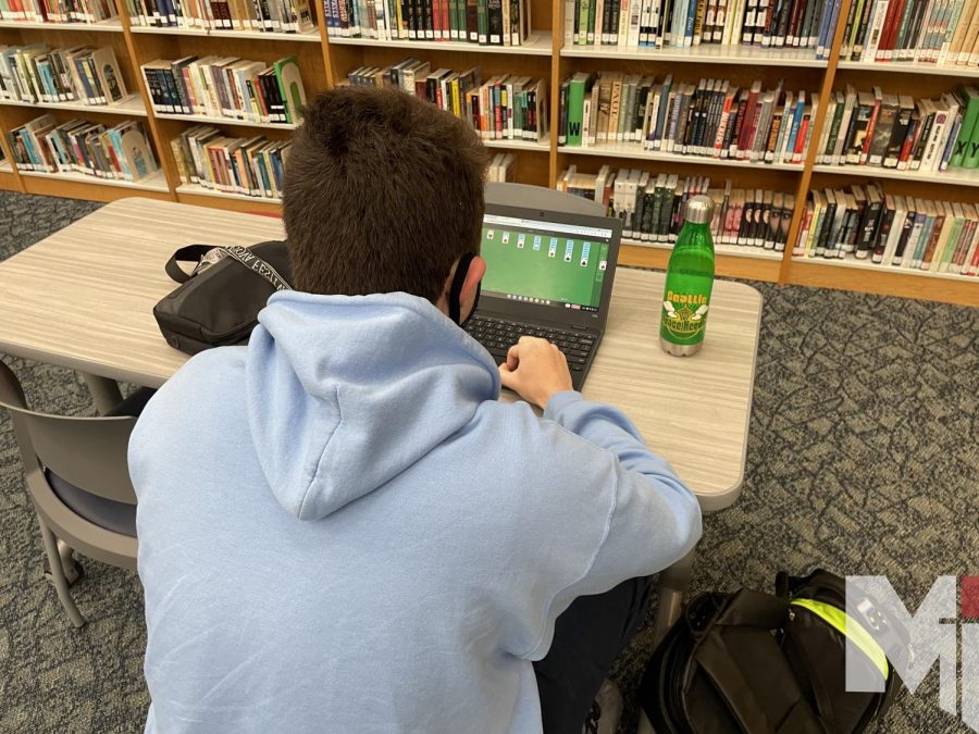Playing solitaire before school, junior Willian Watson enjoys playing all kinds of games to have fun and a sense of relaxation.