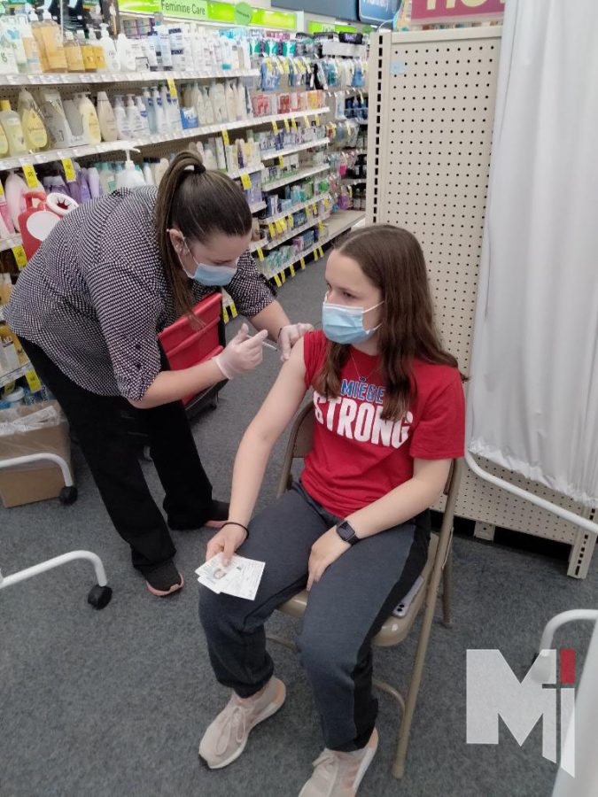Listening to the instructions given by the pharmacist, sophomore Alena Gillespie feels a quick poke as she receives the COVID-19 vaccine. 