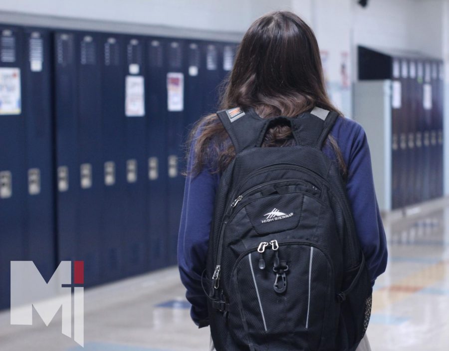 Walking through the halls, junior Savana Hernandez carries her supplies in her backpack. She has had to transfer her supplies to her locker due to a change in policy.