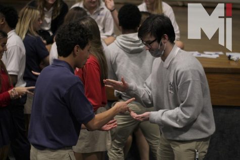 Becoming victorious, junior Caleb Oblepias defeats junior Aiden Post in a round of Rock Paper Scissors during the Fully Alive retreat. 