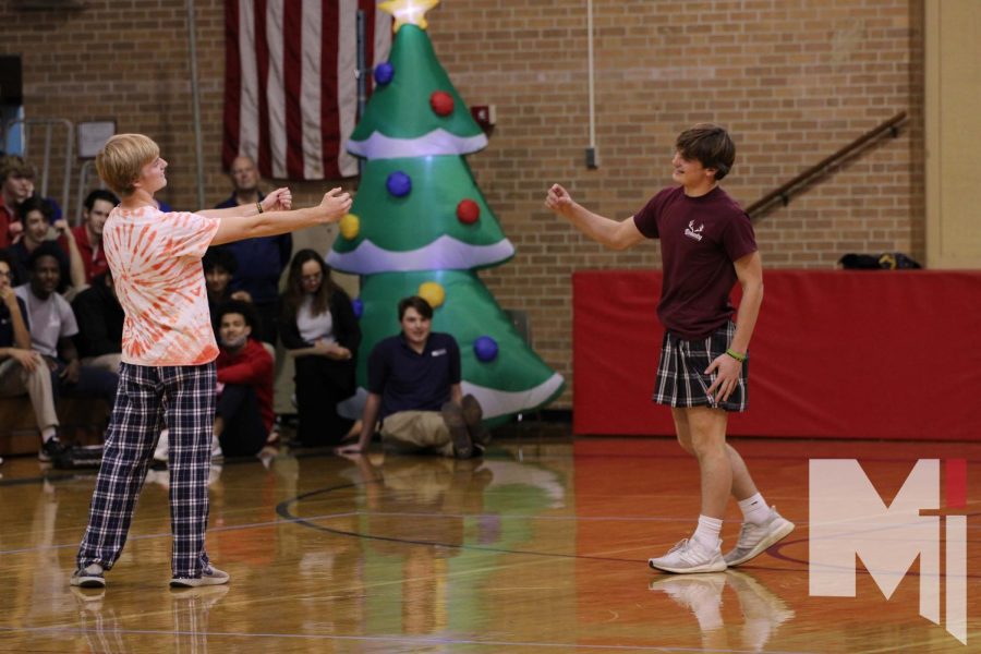 Reaching out to each other, junior Stephen Neenan and sophomore Connor Neenan represent the Bohaty Herd in the Christmas lip-synch competition. The brothers sang to “All I Want for Christmas is You.”