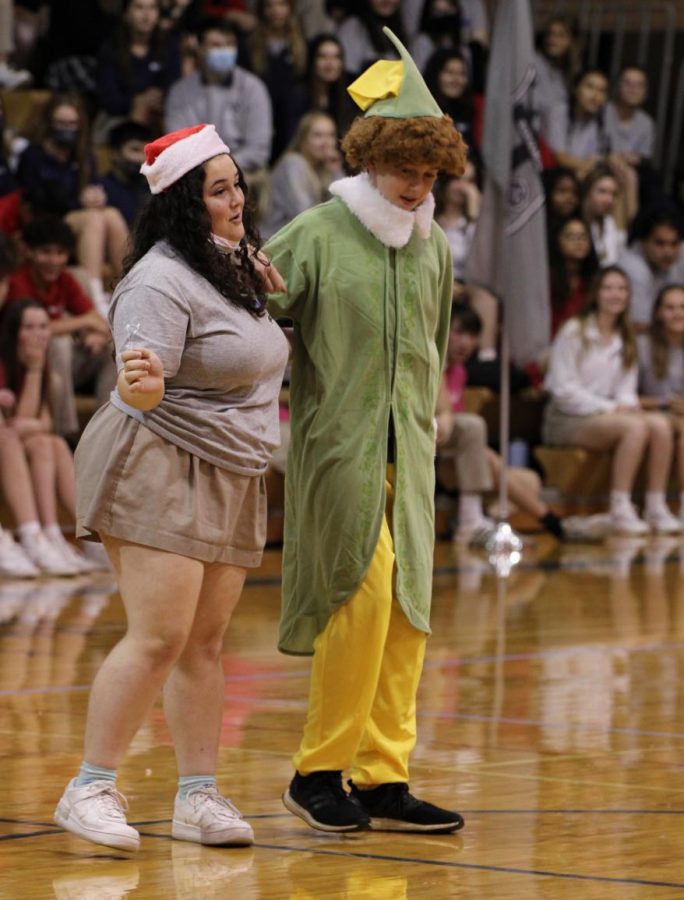 Dressed up as Buddy the Elf from head to toe, sophomore Andrew Brown dances alongside senior Cara Parisi. Millie herd took second place in the holiday lip-sync battle.