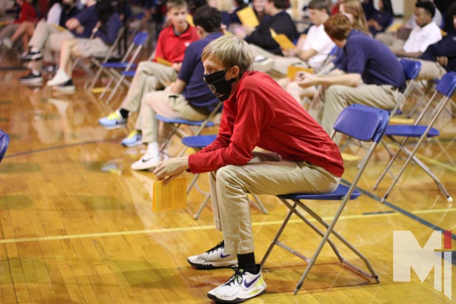 During Reconciliation, junior Jordan White sits in the gym with the rest of the junior class on the “Get Right” day on Dec. 1. The service is offered at Miege once during Advent and once during Lent.