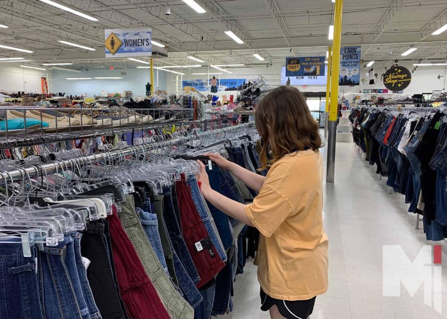 Grace Alford searching through the jeans section at City Thrift.