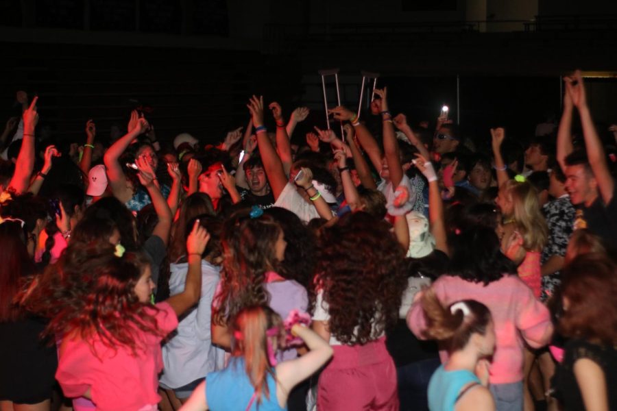 With 80s music playing, students create a mosh pit during the 80s mixer. 