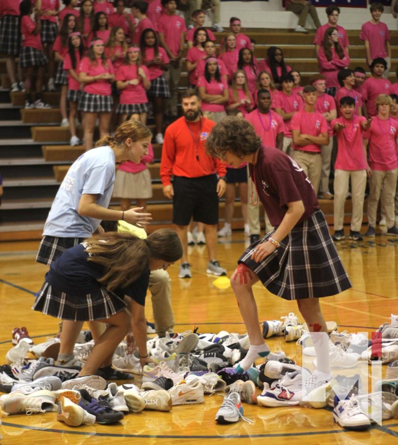 Looking for their shoes, sophomores Clare Hansen and Zoe turnpin participate in the shoe relay on Aug.17.