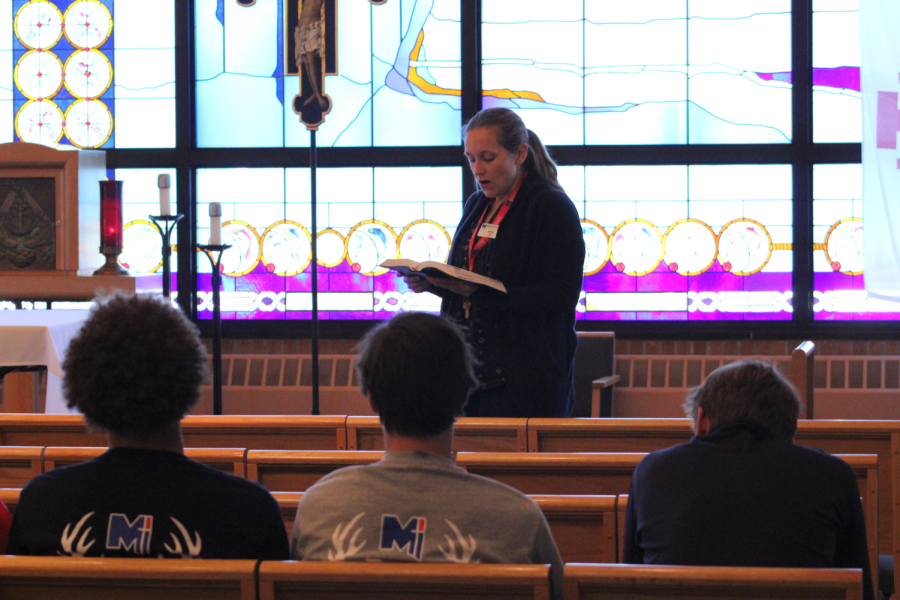Reading from the Bible, junior Theology teacher Patricia Arnold takes her students to the chapel for chapel time. Chapel time is when Arnold reads verses from the Bible and get time to reflect.