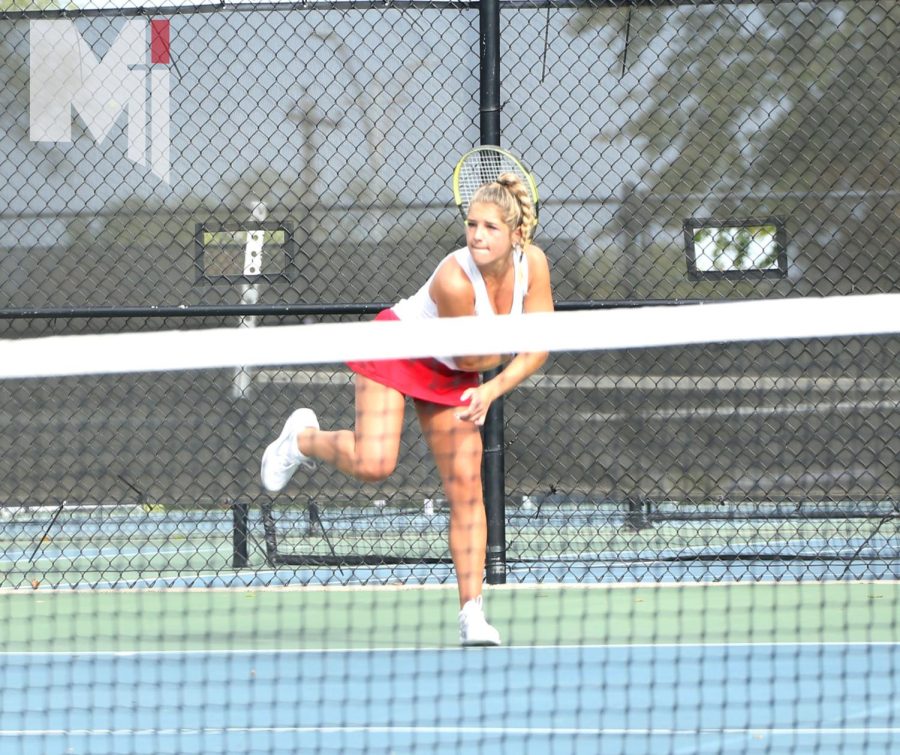 Reaching forward, senior Lauren Myers hits the ball to her opponent. Myers has been on the tennis team for four years and has gone to state all four years. I went on to the court knowing that these were my last matches, Myers said. It was sad and hit me that it was my last time competing.