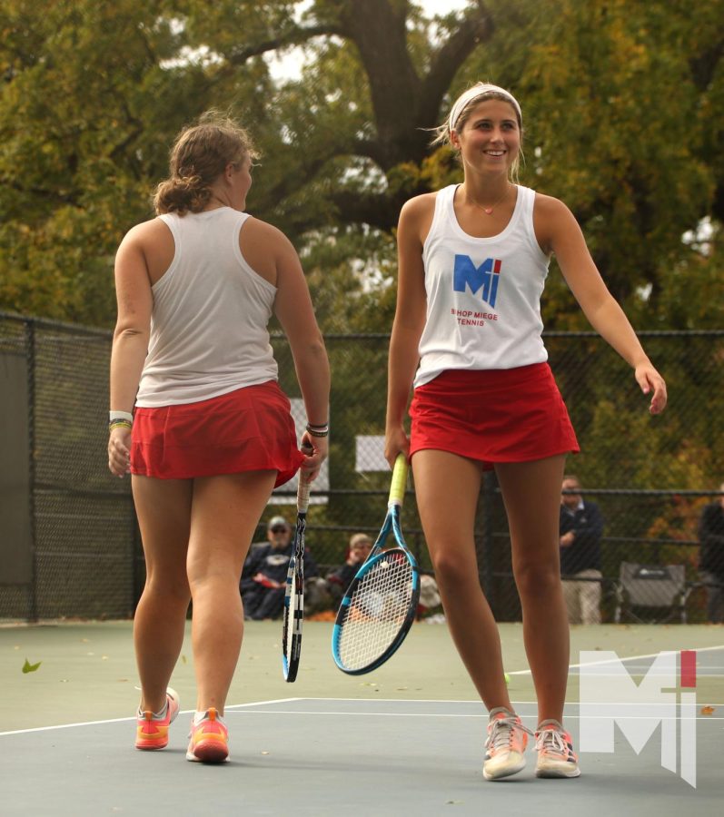 Coming off a winning shot, senior Grace Tucker and junior Livi Shull bump rackets for good luck as they prepare for the next shot. They have been tennis doubles partners since middle school. It was bitter-sweet competing our last match together because we have been playing with each other for so long, Tucker said. But I am glad that we won our last match together.