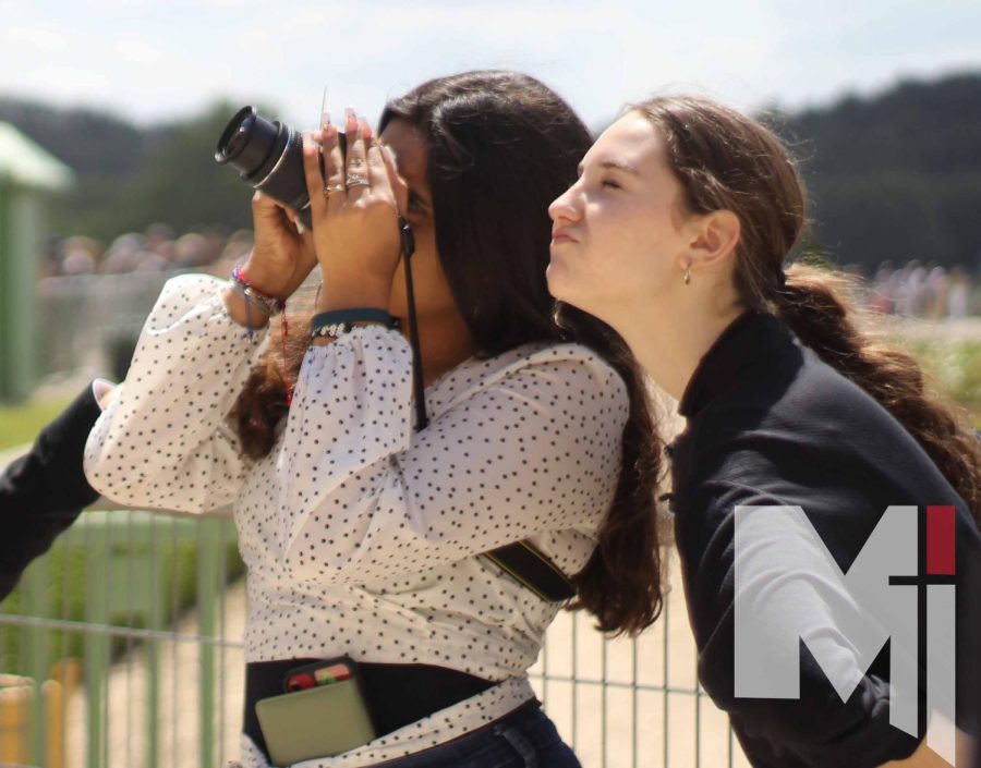 Looking up to take a picture, sophomore Paloma Maldonado Banda and junior Gabby Brown stand in front of the Château Royal d’Amboise. The group of students visited the castle on May 30.