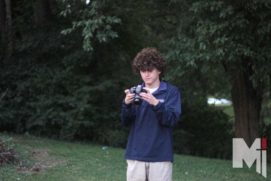  Junior Luke Frenzel looks through his pictures, searching for the perfect shot. Frenzel often uses the Canon Rebel T8i since it is versatile and fairly easy to use. “The rebel series has fairly entry-level cameras, which makes it pretty easy to pick up.” Frenzel said. 