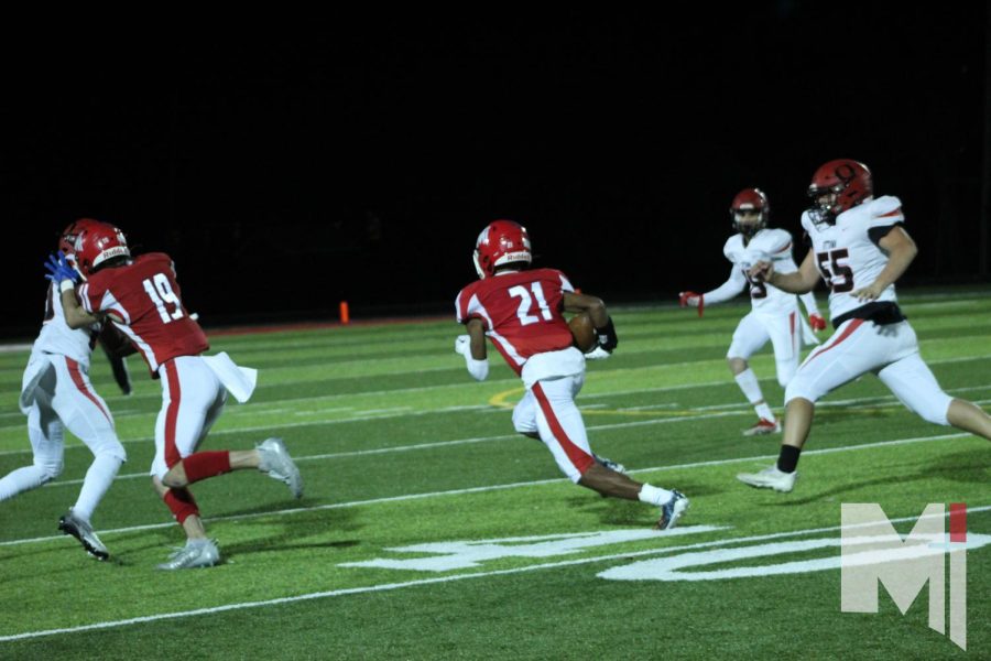 To score a touchdown, sophomore Teryn Jackson runs past the Ottawa defense line.