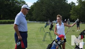 Preparing for an upcoming tournament, freshman Ashley Myers and JV golf coach Dennis Mueller talk about tips for the driving range.