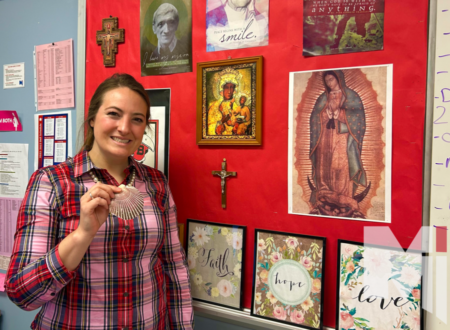 Alicia Baehr stands next to her collection of religious souvenirs 