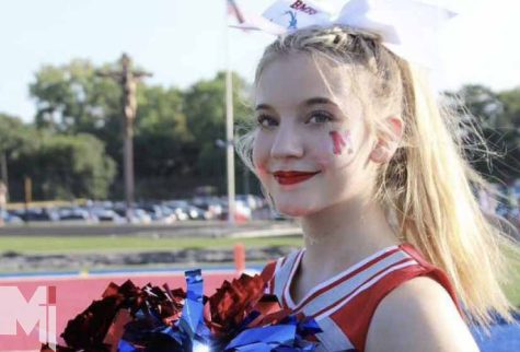 Mairin Putnam, one of two freshman on varsity cheer, prepares for a new season with her team