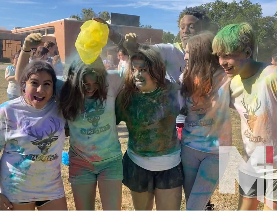 Freshman Kate Nicely and her friends celebrate after the color run. 