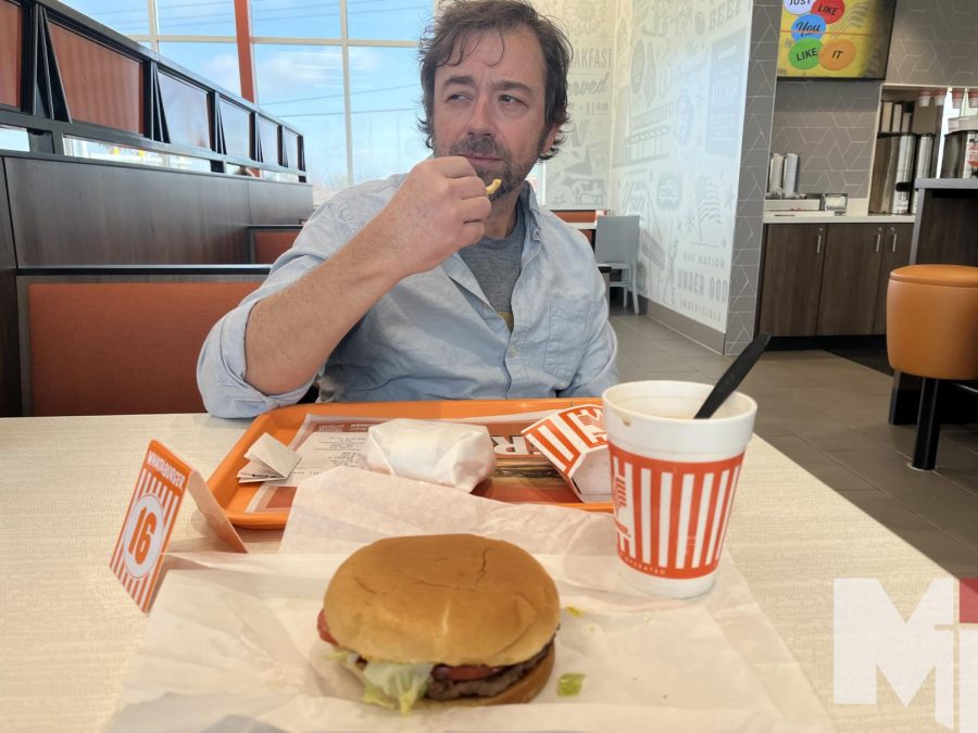 Matt McCaffree enjoys Whataburger at the new location on 113th and Nall. Sophomore Julia McCaffree ate their with her dad.
