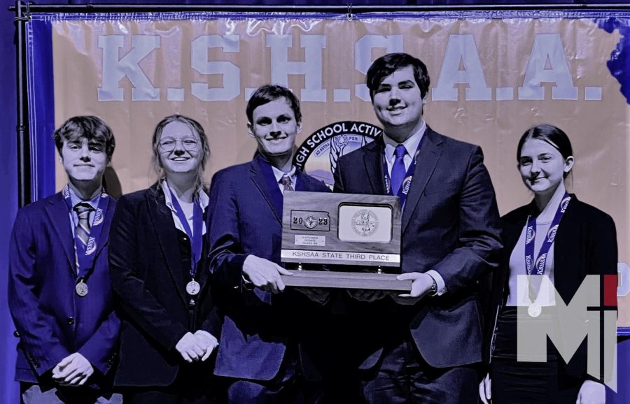 The four-speaker team stands with their third place trophy at state on Jan. 14. 