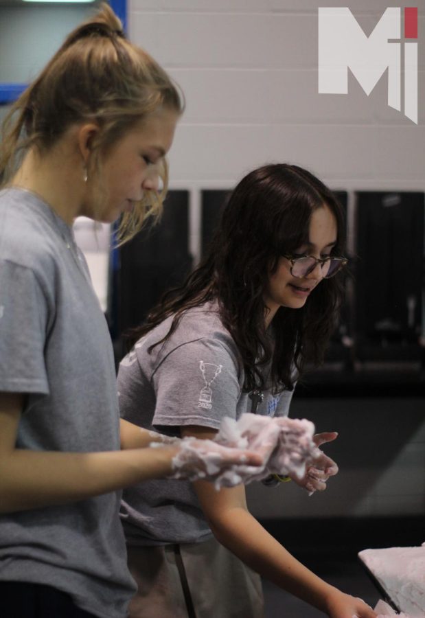 Trying to win the competition, senior Lindsay Casper and junior River Ball try to make shaving cream art. This competition took place on Jan. 19 as well as castle ball.