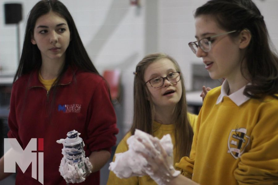 With shaving cream in hand, junior Laine Liston, Evie McBride and Lola Kernell get ready to finish up their shaving cream art. Competitors had 45 minutes to complete their art, with four people to a table.