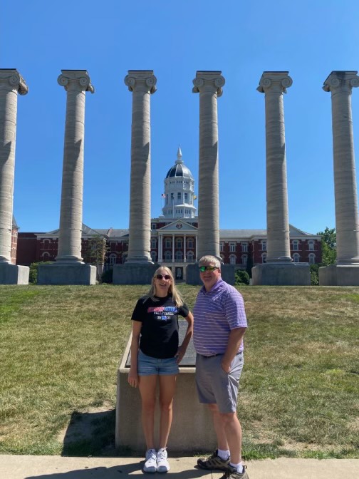 In front of the University of Missouri building, senior Lauren Lueckenotto poses with her dad during a college visit. Lueckenotto went on three college visits before deciding on Kansas State University.