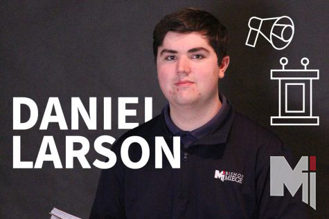 Posing for the camera, senior Daniel Larson holds a notebook he uses during tournaments.