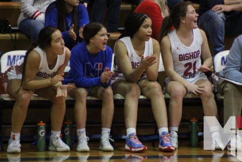 Sitting and cheering from the side line, senior Joanna Gibson, juniors Carly Kurt and Skyler Smith and senior Lexi Kurt watch the Blue Valley North game, a 39-68 loss. “Leaving the people on the team makes me sad, but I am proud of my years on the team,” Kurt said.