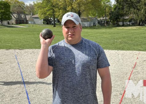 Coach Ryan Gravy Boat Graves readies the shotput, a familiar motion for a coach who just three years ago was throwing the shotput for Avila University.