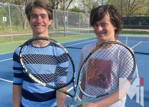 After practice, sophomore Joe Schmidt and Matthew Morris pose for a doubles picture.