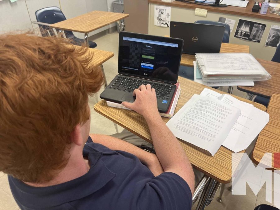 Junior Jackson Burroughs boots up a game of online chess during class. Burroughs is one of many students who have recently discovered the ancient game through websites like Chess.com.