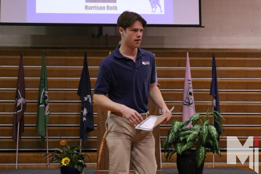 After receiving one of his awards, senior Harrison Roth makes his way back to his seat to cheer on fellow classmates. Roth received the Sister Martina Rockers Above and Beyond Award during the senior award assembly on May 2. 
