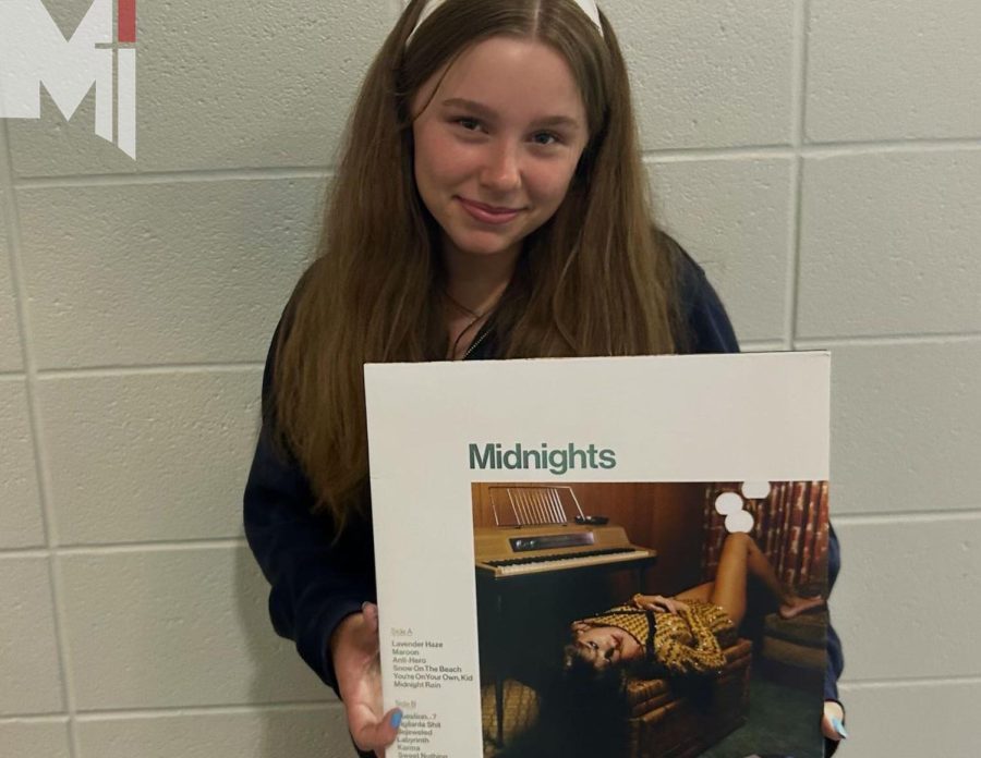 Freshman Isabella Dessert shows off her  her favorite vinyl MIdnights by Taylor Swift.  Dessert and others will be attending the concert at Arrowhead on July 7. 