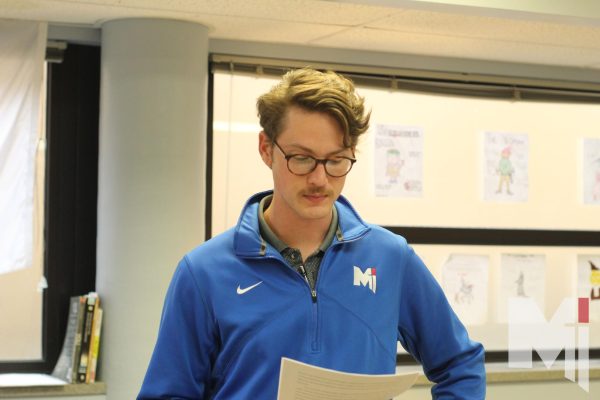 Junior theology teacher Mr. Brock Hess begins his class by reading a poem about faith to his students, as they are reflecting on a Bible passage. 