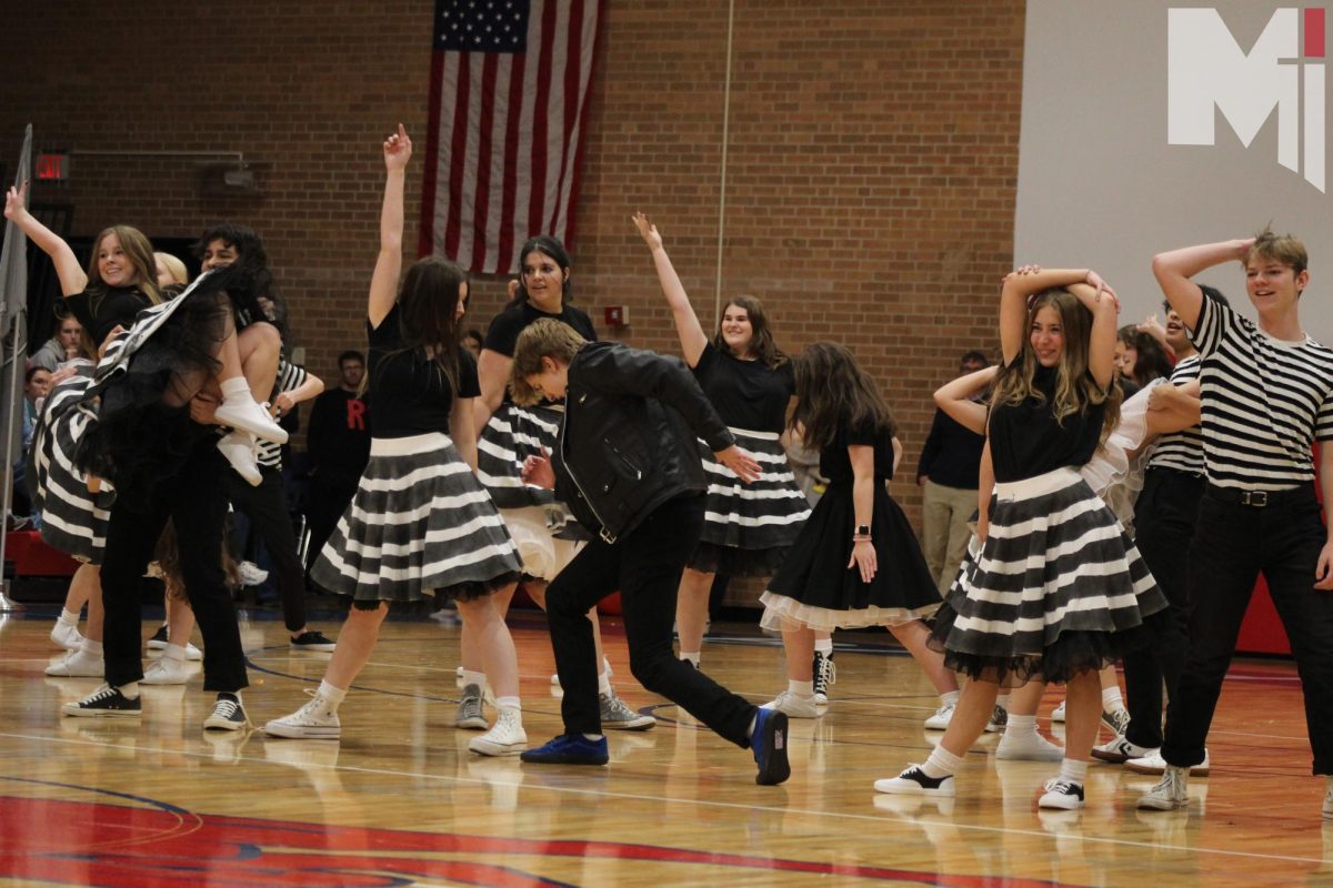 Rockin and Rollin: Seniors Peter Dessert and Megan Ruf hit their final pose in the Halloween Assembly.