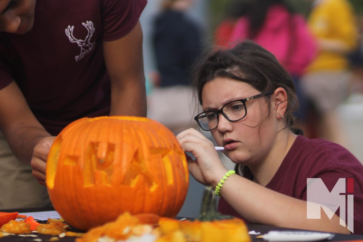 Freshman Evelyn Howard in pumpkin carving herd competition.