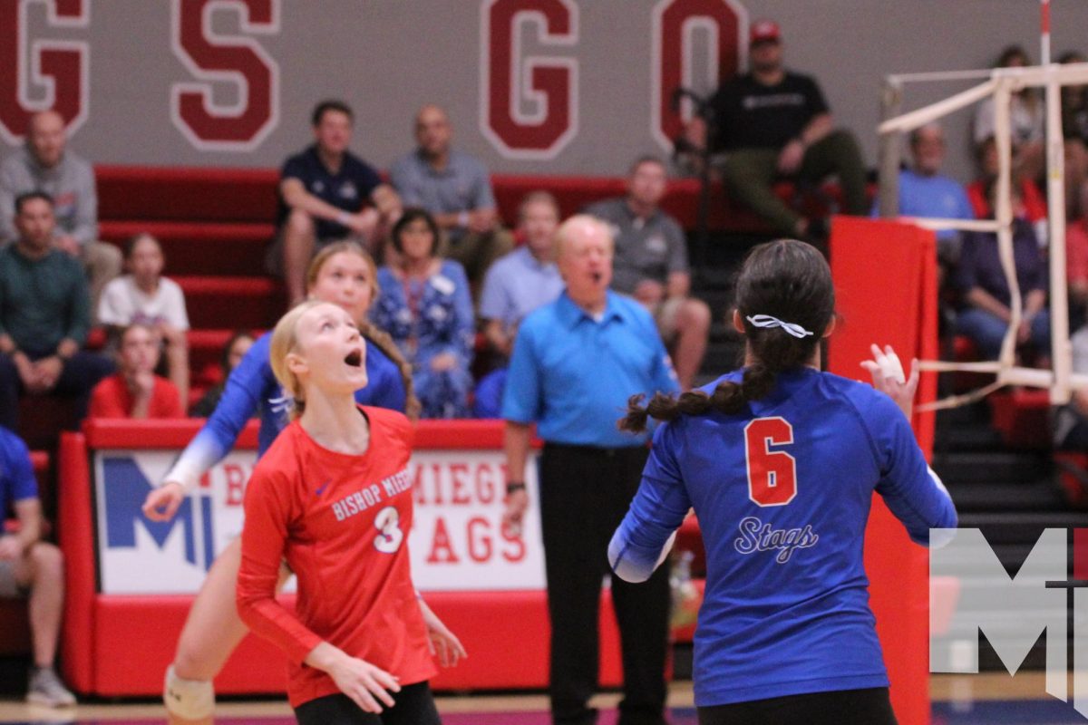 Seniors Gabby Anderson and Ava Martin position themselves to play a ball high in the air during their match against St. James on September 14. Anderson and Martin shared team captain roles throughout this season, which was capped by a state title on Saturday.