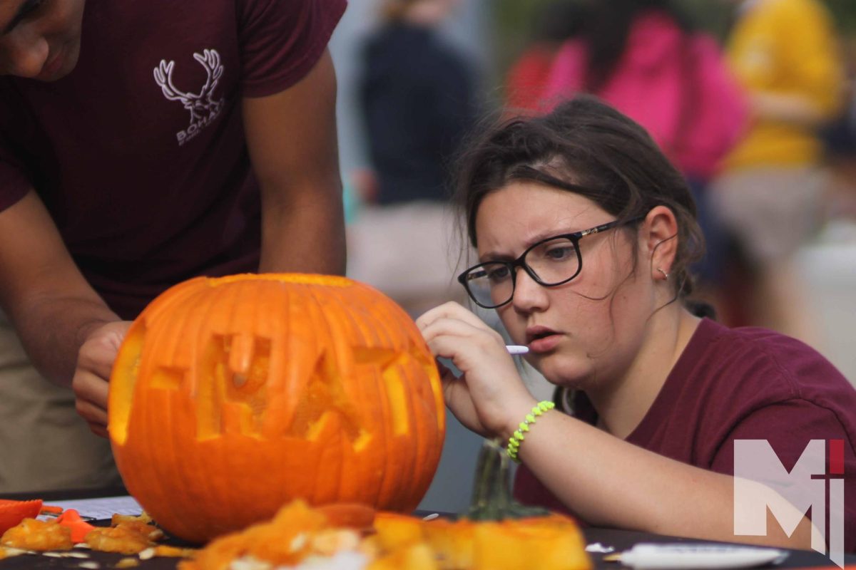 At the herd competition freshman Evelyn carves a pumpkin.
The pumpkin carving competition was recently added to herd competitions. 