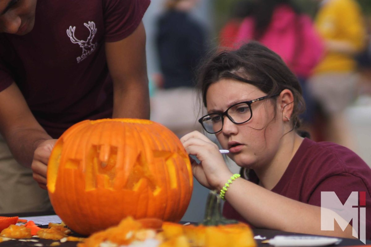 At the herd competitions freshman Evelyn Howard carves pumpkin for Bohaty herd. 