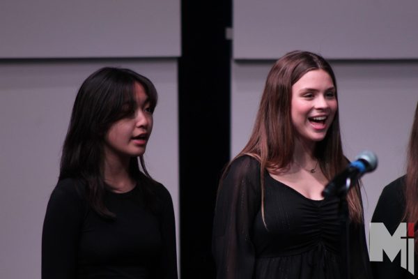 Serenading the crowd, freshman Adeline Balino sings with Novum Cantores. Balino shares how Christmas concerts help challenge students. “I like improving my skills in singing and being with friends,” Balino said. 
