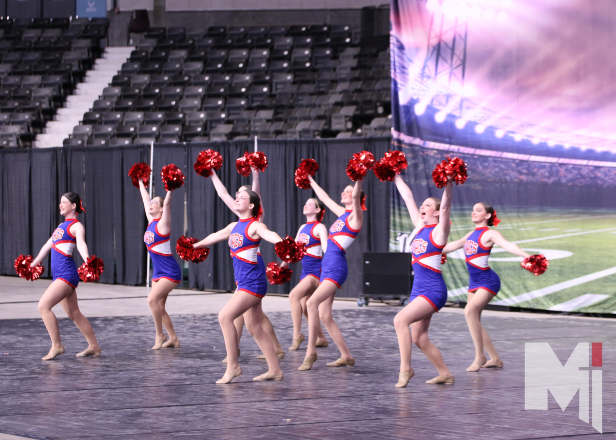 The dance team takes their final spirit stance before performing their fight song routine.