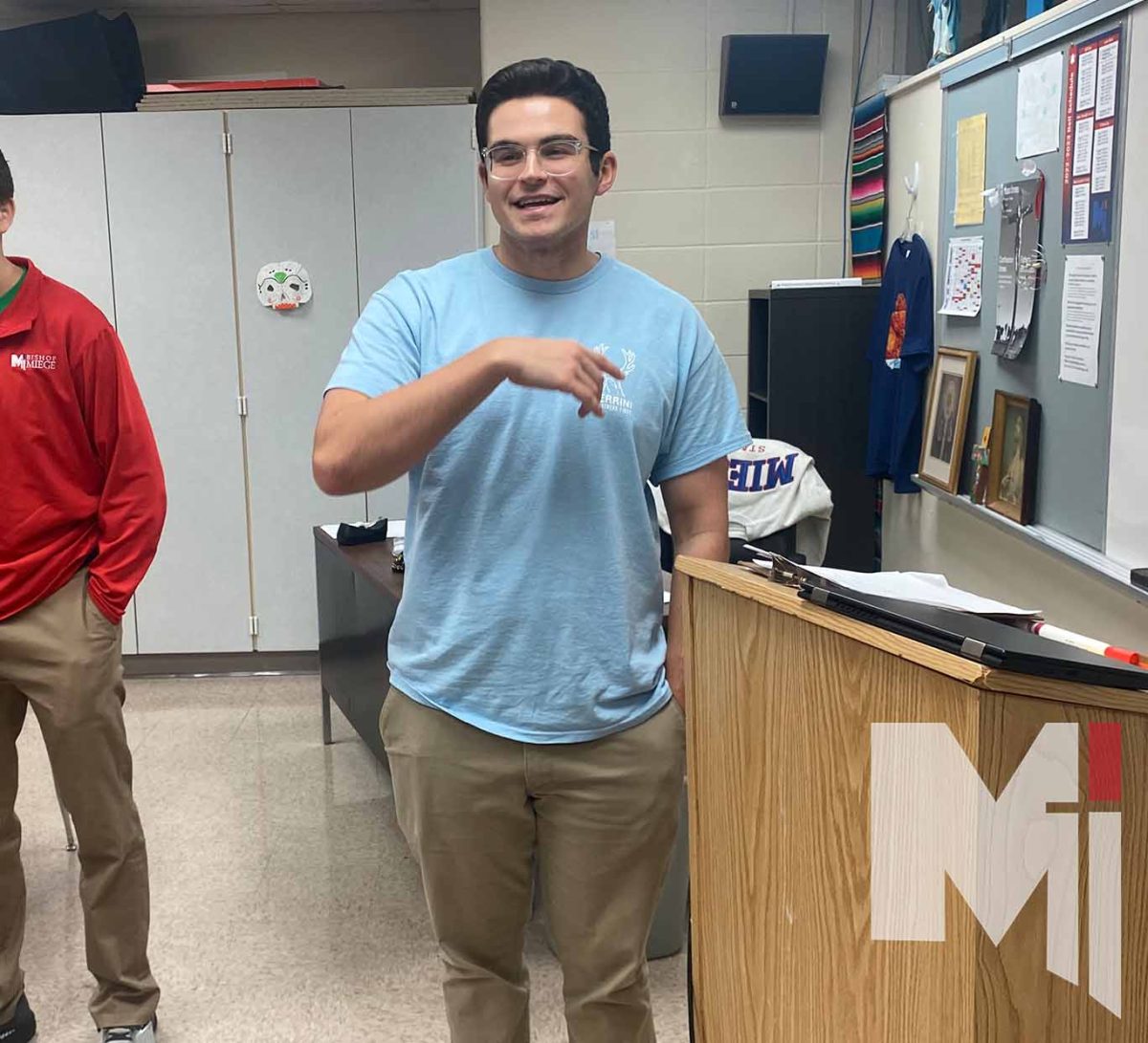 Ryan Geris stands in front of the class and teaches Spanish to his students