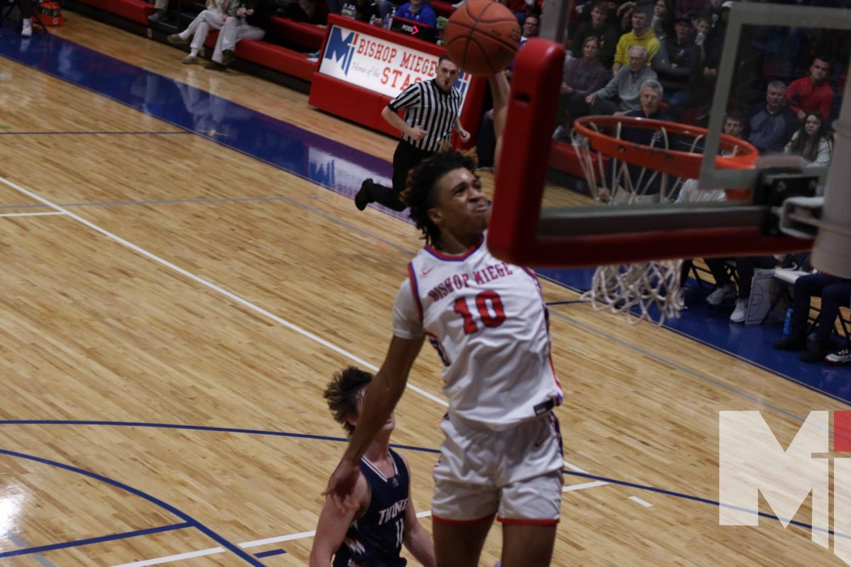 Senior Howard Peoples rises up for a dunk against St. James Academy on January 5. Miege won the contest 48-43. 