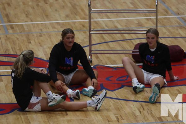 Sophomore Mary Grant, Junior Kirston Verhulst, and Senior Livi Shull stretch before their game against St. James Academy on January 5. The girls team finished the regular season with a 17-3 record and at the top of the EKL standings.